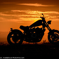 Buy canvas prints of A silhouette of a custom made chopper motorbike against a colourful sunset by Ambrosini V