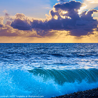 Buy canvas prints of Sunset from Brighton beach with light glistening on rolling waves by Iain Lockhart