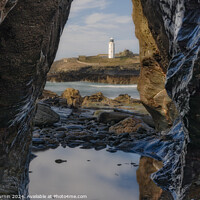 Buy canvas prints of Godrevy's Glimpse: Lighthouse Beyond the Rocky Portal by Andy Durnin