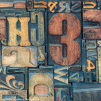 Buy canvas prints of A collection of old used wooden printers blocks by Phil Lane