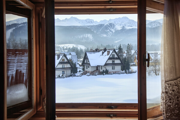 Beautiful view from an open window to a winter vil Picture Board by Olga Peddi