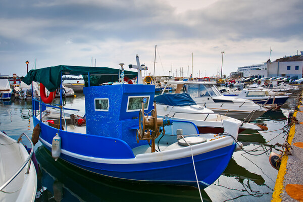 Greek fishing boats stays parked near sea pier at Vlychada town  Picture Board by Olga Peddi