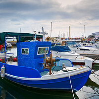 Buy canvas prints of Greek fishing boats stays parked near sea pier at Vlychada town  by Olga Peddi