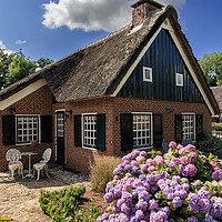 Buy canvas prints of Traditional dutch brick hous in idyllic Giethoorn  by Olga Peddi