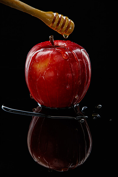 Red apple with honey on black Picture Board by Olga Peddi
