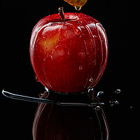 Buy canvas prints of Red apple with honey on black by Olga Peddi