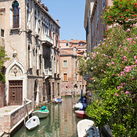 Buy canvas prints of A Venice canal with boats by Sean Tobin