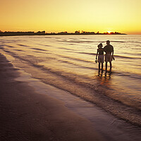 Buy canvas prints of couple along beach at sunset by Dave Reede