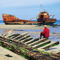 Buy canvas prints of woman sitting on remains of wooden shipwreck viewing shipwreck by Dave Reede
