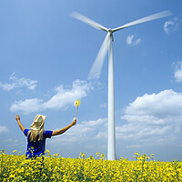 Buy canvas prints of girl with pinwheel viewing wind turbine by Dave Reede