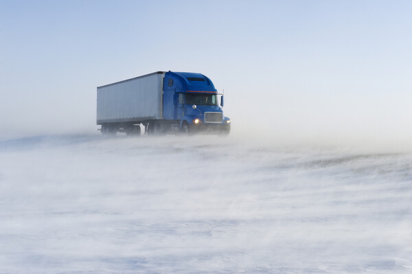 truck on road covered with blowing snow Picture Board by Dave Reede