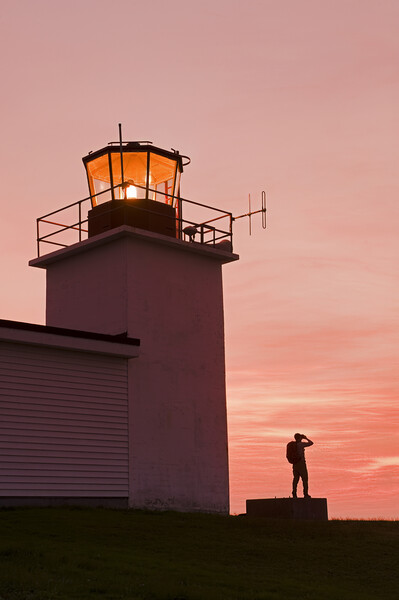 hiker looking out from Grand Passage lighthouse Picture Board by Dave Reede