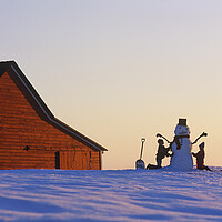 Buy canvas prints of a family make a snowman in front of a red barn by Dave Reede