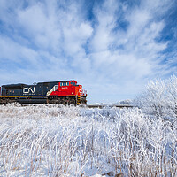 Buy canvas prints of Train Passing a Snowy Landscape by Dave Reede
