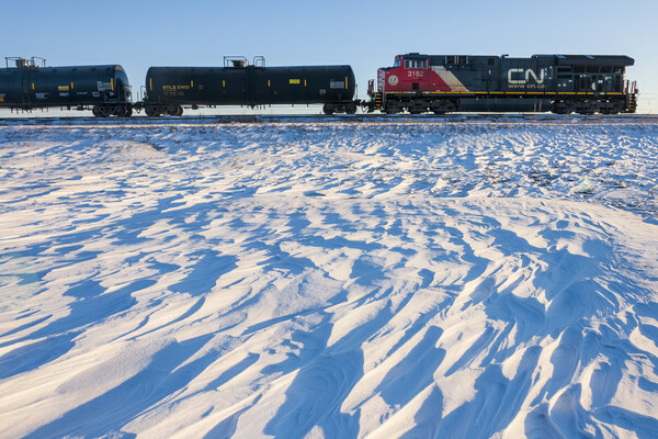 Locomotive Pulling Tanker Cars Passing Snow Drift Patterns Picture Board by Dave Reede