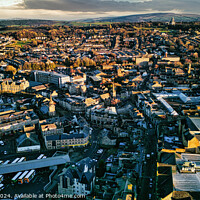 Buy canvas prints of Aerial view of a city Lancaster at sunset with warm lighting highlighting the buildings and streets, showcasing the urban landscape. by Man And Life