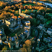 Buy canvas prints of Aerial view of a historic Lancaster castle surrounded by greenery and a river at sunset. by Man And Life