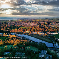 Buy canvas prints of Aerial view of Lancaster city at sunset with a river flowing through, highlighting the urban landscape and green spaces under a dramatic sky. by Man And Life