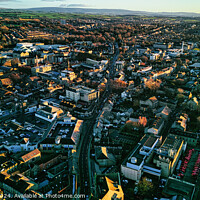 Buy canvas prints of Aerial view of a cityscape at sunset with warm lighting, showcasing dense buildings and streets leading to the horizon in Lancaster. by Man And Life