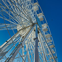 Buy canvas prints of Low-angle view of a Ferris wheel against a clear blue sky in Lancaster. by Man And Life
