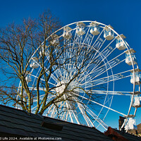 Buy canvas prints of Ferris wheel against a clear blue sky, partially obscured by a rooftop, with bare trees in the background in Lancaster. by Man And Life