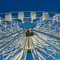 Buy canvas prints of Ferris wheel against a clear blue sky, symmetrical view from below in Lancaster. by Man And Life