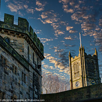 Buy canvas prints of Historic stone buildings with towers against a dramatic sky at dusk in Lancaster. by Man And Life