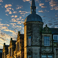 Buy canvas prints of Historic stone building with a spire against a dramatic sky with golden sunset clouds in Lancaster. by Man And Life