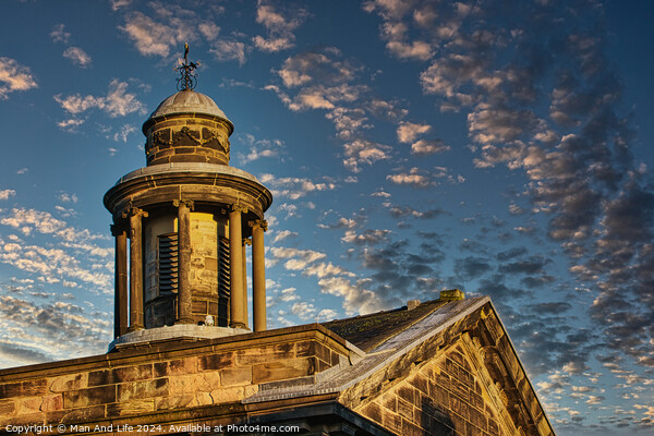 Historic stone building with a dome under a blue sky with scattered clouds at sunset in Lancaster. Picture Board by Man And Life
