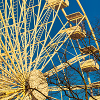 Buy canvas prints of Ferris wheel against a clear blue sky with sunlight casting shadows, conveying a sense of leisure and entertainment in Lancaster. by Man And Life