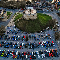 Buy canvas prints of Aerial view of a circular building surrounded by a parking lot with cars during twilight in York, North Yorkshire by Man And Life