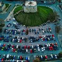 Buy canvas prints of Aerial view of a circular building surrounded by a parking lot with colorful cars, showcasing urban planning and architecture in York, North Yorkshire by Man And Life
