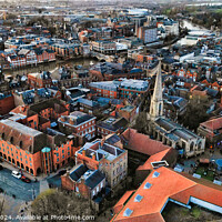 Buy canvas prints of Aerial view of a historic town at dusk with warm lighting, showcasing the urban architecture and streets in York, North Yorkshire by Man And Life