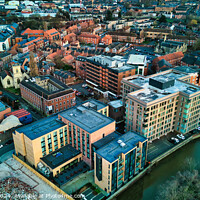 Buy canvas prints of Aerial view of a vibrant urban landscape at dusk with buildings and a river in York, North Yorkshire by Man And Life