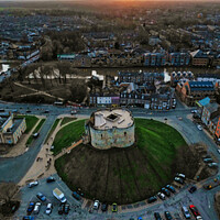 Buy canvas prints of Aerial view of a parking lot and building at sunset with dramatic sky in York, North Yorkshire by Man And Life