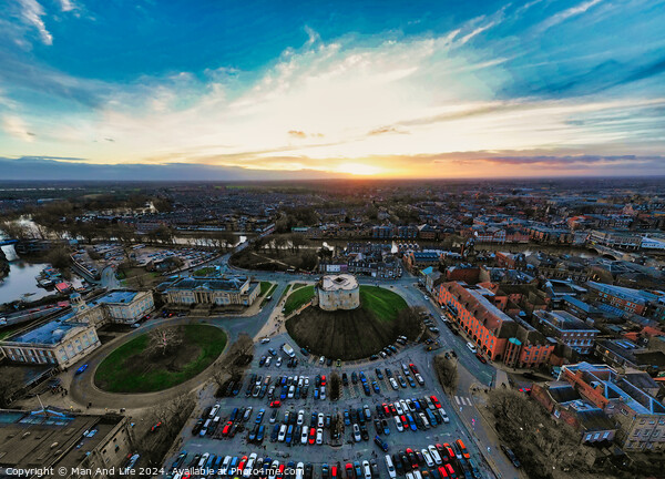Aerial view of a cityscape at sunset with vibrant skies and parking lot in the foreground in York, North Yorkshire Picture Board by Man And Life