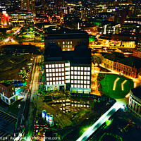 Buy canvas prints of Aerial night view of an illuminated urban office building amidst city lights in Leeds, UK. by Man And Life