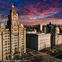 Buy canvas prints of Aerial view of iconic Liverpool waterfront buildings at sunset with dramatic sky. by Man And Life