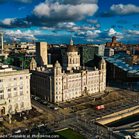 Buy canvas prints of Aerial view of a historic cityscape with dramatic clouds and sunlight, showcasing iconic buildings and a river in Liverpool, UK. by Man And Life