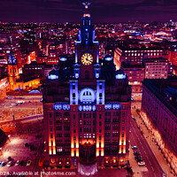 Buy canvas prints of Aerial night view of an illuminated cityscape with a prominent clock tower and urban architecture in Liverpool, UK. by Man And Life