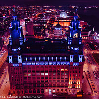Buy canvas prints of Aerial night view of an illuminated historic building in an urban setting with city lights in the background in Liverpool, UK. by Man And Life
