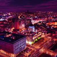 Buy canvas prints of Vertical aerial view of a city at night with illuminated streets and buildings, showcasing urban nightlife in Liverpool, UK. by Man And Life