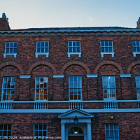 Buy canvas prints of Traditional brick building facade under blue sky at dusk in York, UK. by Man And Life