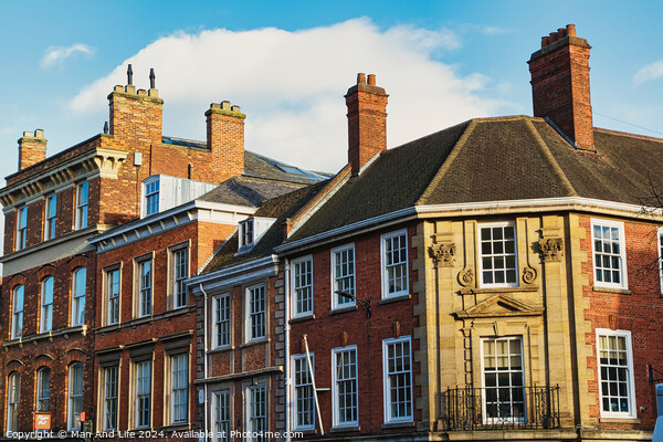 Historic brick buildings with classic British architecture under a clear blue sky in York, UK. Picture Board by Man And Life