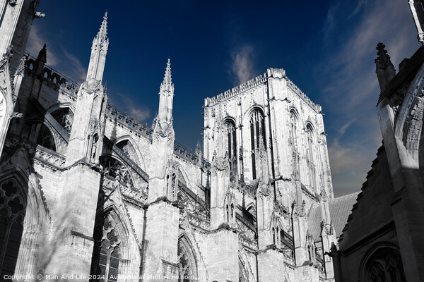 Gothic cathedral architecture with spires against a blue sky with clouds in York, UK. Picture Board by Man And Life