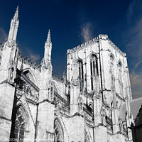Buy canvas prints of Gothic cathedral architecture with spires against a blue sky with clouds in York, UK. by Man And Life
