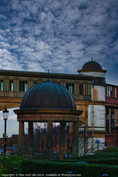 Dramatic sky over an architectural dome and building with a bridge in the background in Harrogate, England. Picture Board by Man And Life