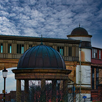 Buy canvas prints of Dramatic sky over an architectural dome and building with a bridge in the background in Harrogate, England. by Man And Life