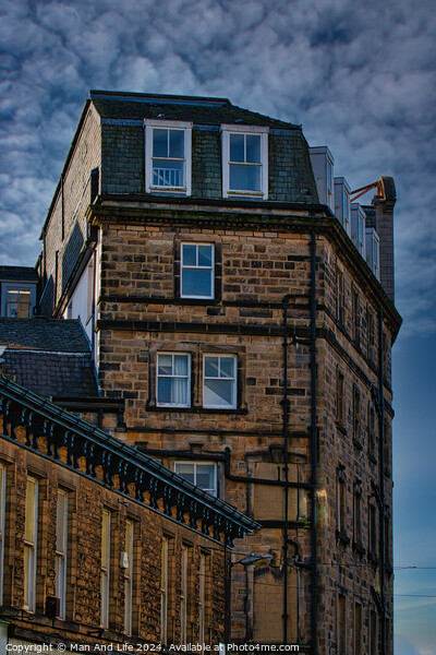 Vintage building corner against a dramatic cloudy sky in Harrogate, England. Picture Board by Man And Life