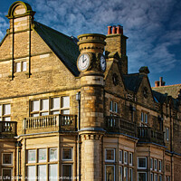 Buy canvas prints of Historic stone building with clock tower under blue sky in Harrogate, England. by Man And Life